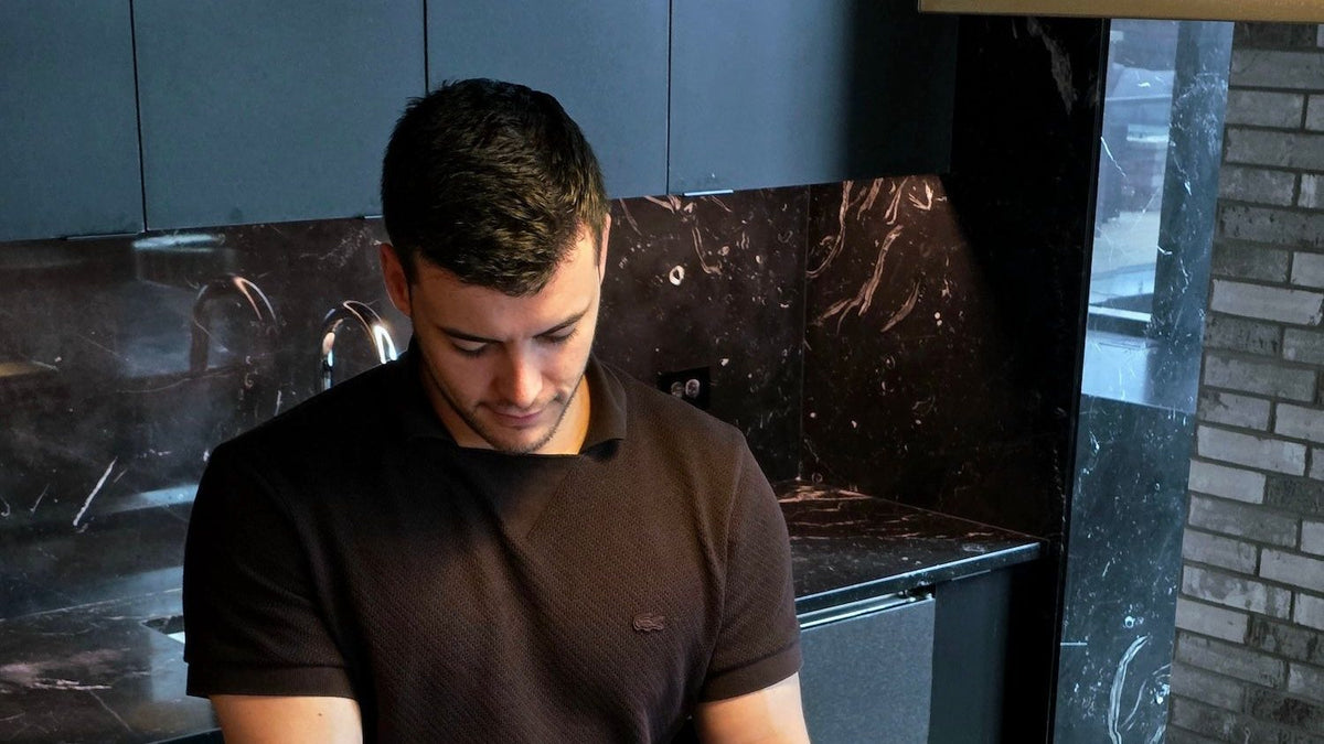 Alex, founder of Anaerobic, at a kitchen counter making a pour-over